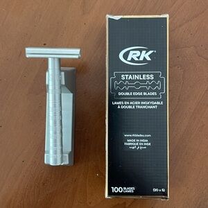 Stainless Henson razor with stand and about ½ box of double edge blades.